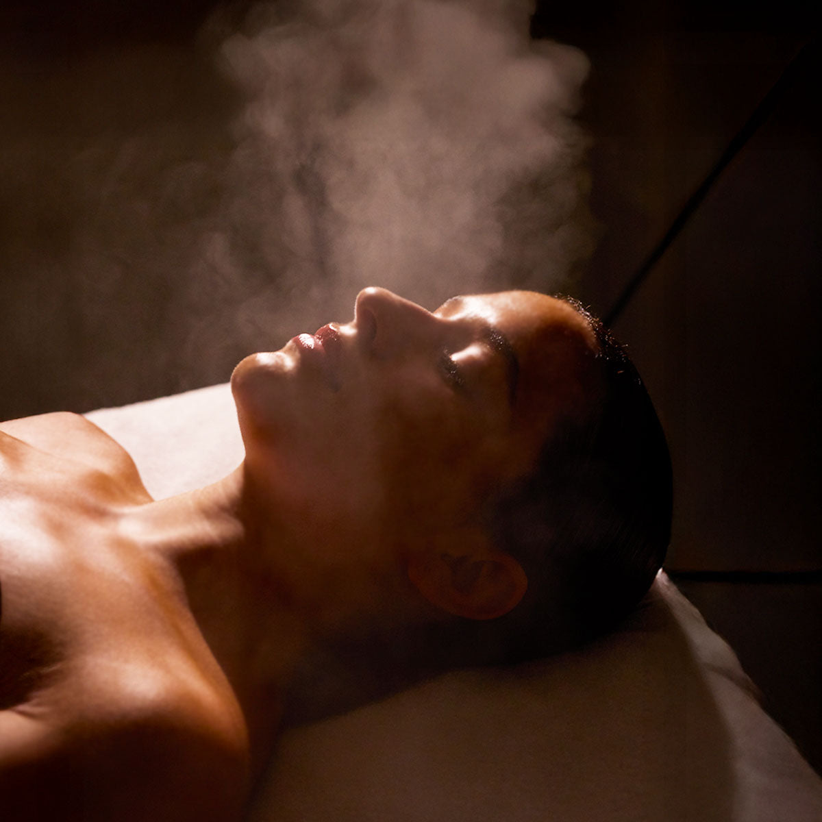 Guest resting during a facial as steam rises